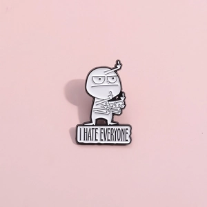 Detail of white enamel lapel pin with I HATE EVERYONE text on pink background