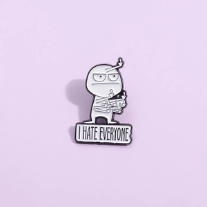 Cartoon enamel pin with I HATE EVERYONE text and humorous rebel character design