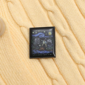 Detail of square enamel pin with Van Gogh style car camping art on yellow knit fabric