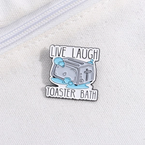 Macro shot of Live Laugh Toaster Bath enamel pin on white canvas background