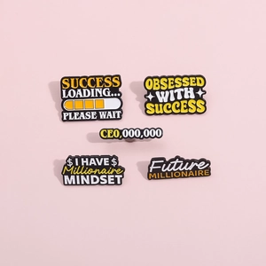 Detail view of five creative enamel success brooches on a pink background with text