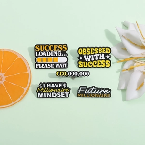Motivational enamel pin set with yellow progress bar text on a fresh green background