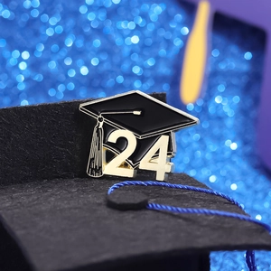 Exquisite 2024 graduation cap brooch with black enamel, gold tassels and blue bokeh