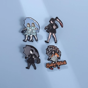 Cartoon enamel pin set with gothic girl designs and Salty Witch text on blue background
