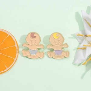Cute baby enamel pins set with glitter accents on a fresh light green background