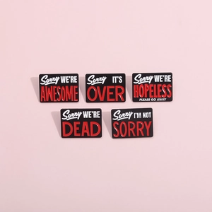 Set of five black enamel pins with creative English quotes and sleek metal finish
