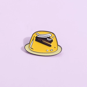 Cute yellow pudding enamel brooch with chocolate sauce topping on a purple background