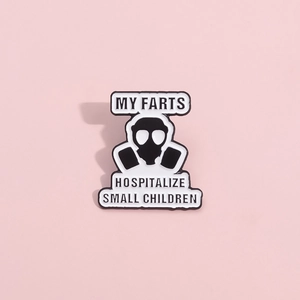 Detail of enamel pin featuring a gas mask and humorous quote in black and white finish