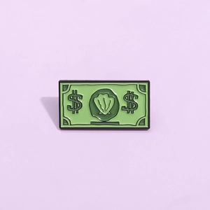 Gros plan d'une épingle émaillée en forme de billet vert avec motif coquillage