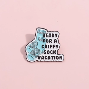 Funny blue grippy sock vacation enamel pin badge with bold text on pink background