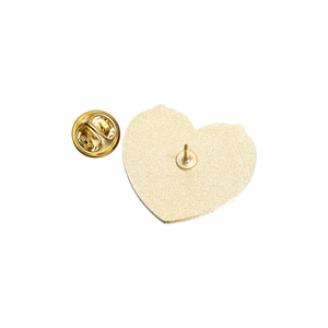 Detailed back view of a heart-shaped gold metal badge with butterfly pin and clasp