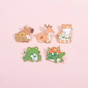 Detailed view of five cute enamel pins featuring animals like capybaras and frogs