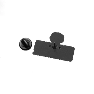 Detail of matte black metal pin back and matching rubber clutch on a white background
