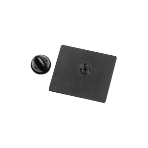 Detail view of the black geometric pin back with durable rubber clutch closure