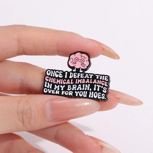 Cartoon pink brain enamel pin badge with funny English quote on black background
