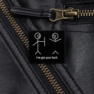 Detail of square enamel brooch with funny stickman and I've got your back text