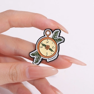 Broche en émail boussole avec verset Jérémie 29:11 et motifs de feuilles vertes
