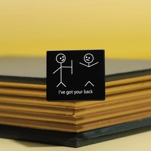 Black square enamel pin with 'I've got your back' minimalist stickman design