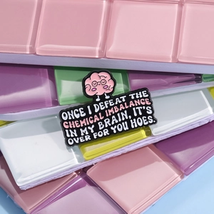 Funny pink brain enamel pin with mental health slogan on a colorful background