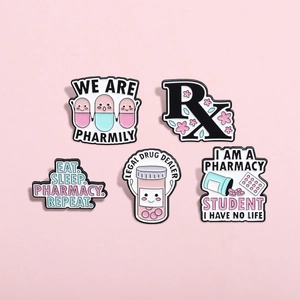 Set of five medical capsule and pharmacy theme enamel pins on a pink background