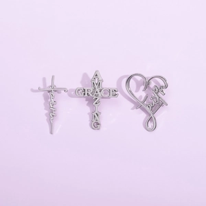 Three-piece silver metal jewelry set featuring faith cross and heart shaped designs