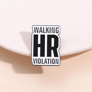 Detailed view of enamel badge with Walking HR Violation text on a beige stand