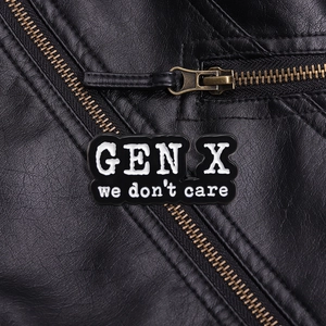 Macro detail of GEN X we don't care enamel badge pinned on a black leather jacket