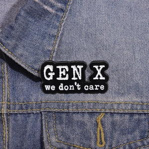 Close-up of Gen X We Don't Care enamel pin badge on blue denim jacket texture