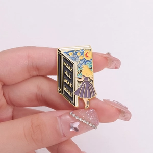 Creative book-shaped enamel pin featuring Van Gogh starry night and Alice in Wonderland quote