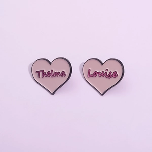 Pink heart enamel pins with Thelma and Louise lettering for best friends jewelry