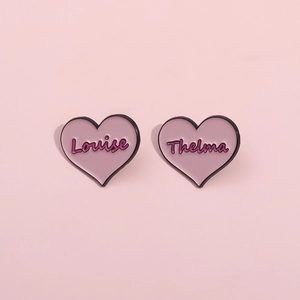 Pink heart enamel brooch set featuring Louise and Thelma script on metal badges
