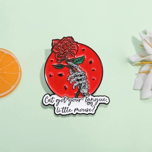 Skeleton hand holding red rose enamel pin badge with gothic quote on green background