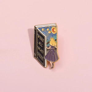 Detailed close-up of Alice in Wonderland enamel pin with Starry Night artistic book design