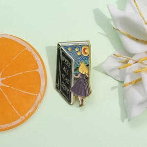 Artistic enamel book brooch with Starry Night motifs and We're All Mad Here text