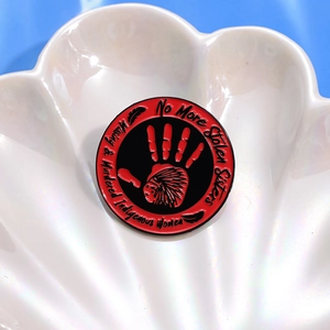 No More Stolen Sisters enamel pin for Indigenous women awareness on shell tray