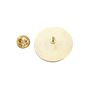 Detail of the golden metal badge back with a needle and butterfly clutch fastener