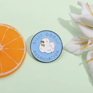 Cartoon Silly Goose Association enamel badge with white duck on blue background