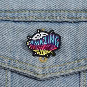 Colorful BE AMAZING TODAY enamel pin badge on blue denim jacket pocket detail