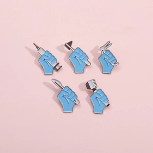 Detail of 5-piece medical enamel pins set with blue fist holding surgical instruments