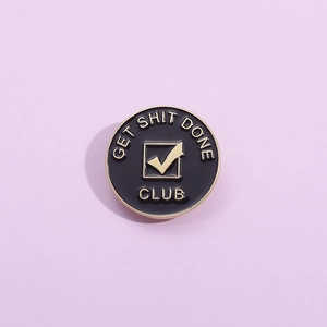 Geometric round black and gold enamel pin with 'GET SHIT DONE CLUB' motivational text