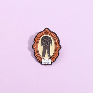 Unique vintage frame enamel pin featuring a suit design and THE SUIT text on violet background