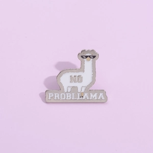 Detailed view of white alpaca enamel pin with sunglasses and No Probllama text