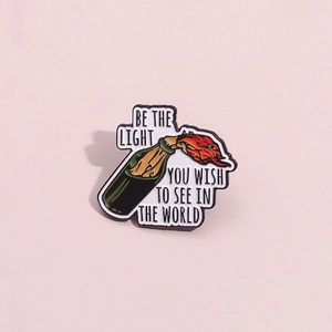 Be the Light enamel pin featuring a molotov cocktail design on a pink background