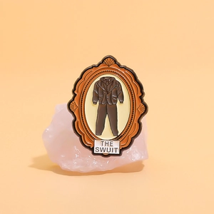 Vintage The Suit enamel pin with portrait frame design on pink mineral rock