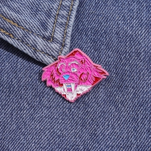 Funny pink cartoon leopard enamel pin accessory on a blue denim jacket collar