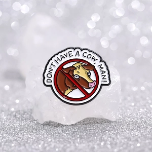 Enamel pin with a shocked cow inside a red circle and Don't Have A Cow Man text