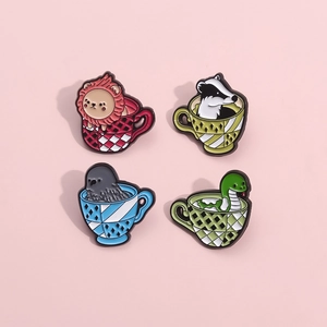 Detailansicht von vier Comic-Emaille-Pins mit tassenförmigen Tieremblemen für Kleidung
