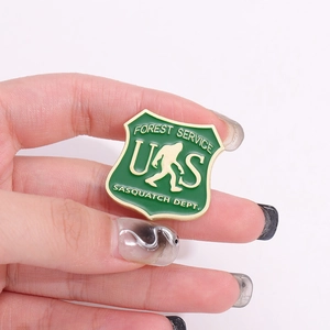 Creative green forest service badge with a golden bigfoot sasquatch silhouette