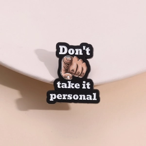 Zinc alloy enamel pin with 'Don't take it personal' text and finger gesture design
