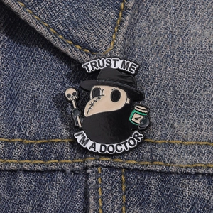 Plague doctor enamel pin with raven mask on denim jacket lapel, creative metal badge